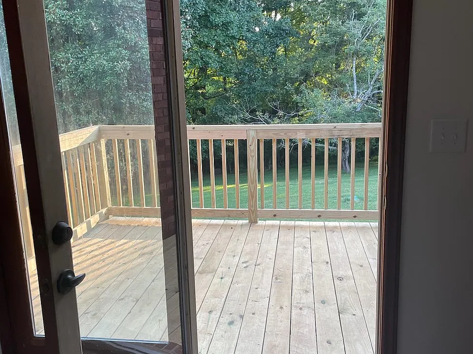 French doors in living space leading out to brand new deck