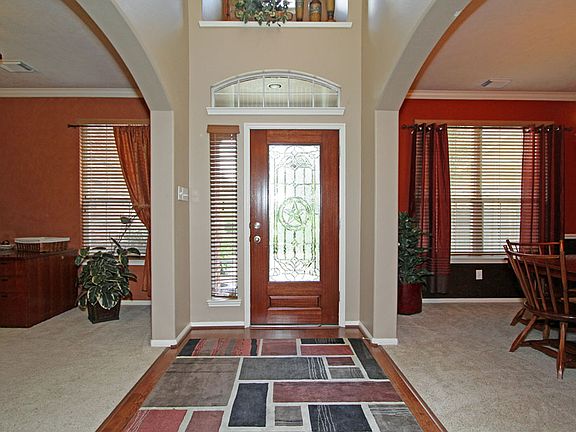 Wood floor entry way & both formals with arched openings & custom paint