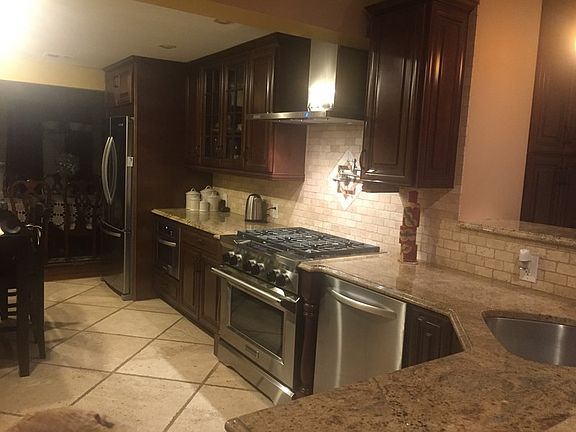 Gorgeous Fully Updated Kitchen
						:
						Custom cabinets, travertine floors/tiles and all new appliances - 6 burner stove