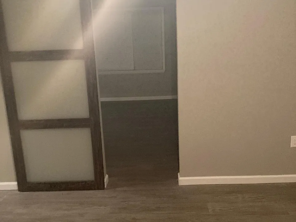 Bedroom #2 with sliding door opening into the living room.