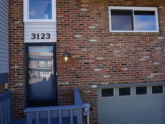 The immaculately kept brick town home will impress guests.