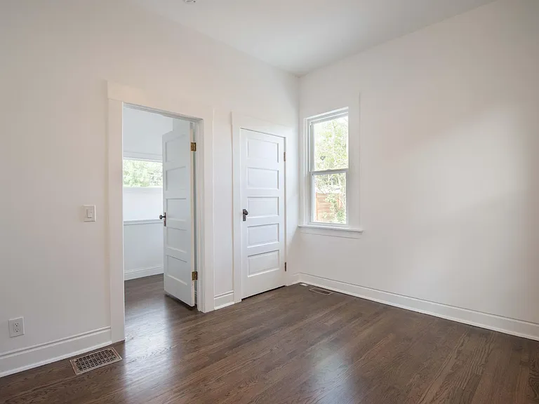 Primary bedroom and closet with view into hallway.