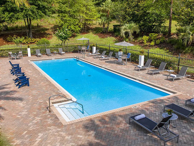 Refresh your day in our serene swimming pool, surrounded by lush greenery and thoughtfully designed outdoor seating areas.