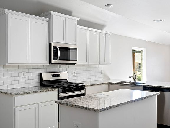 The kitchen of the Alfalfa has beautiful white cabinets.