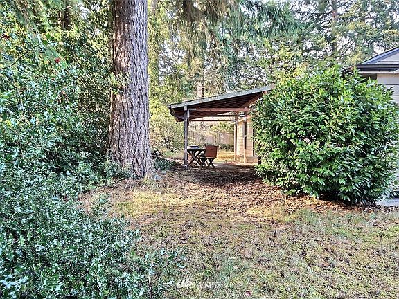 The rear of the home is pictured here and includes the partially coved rear patio.