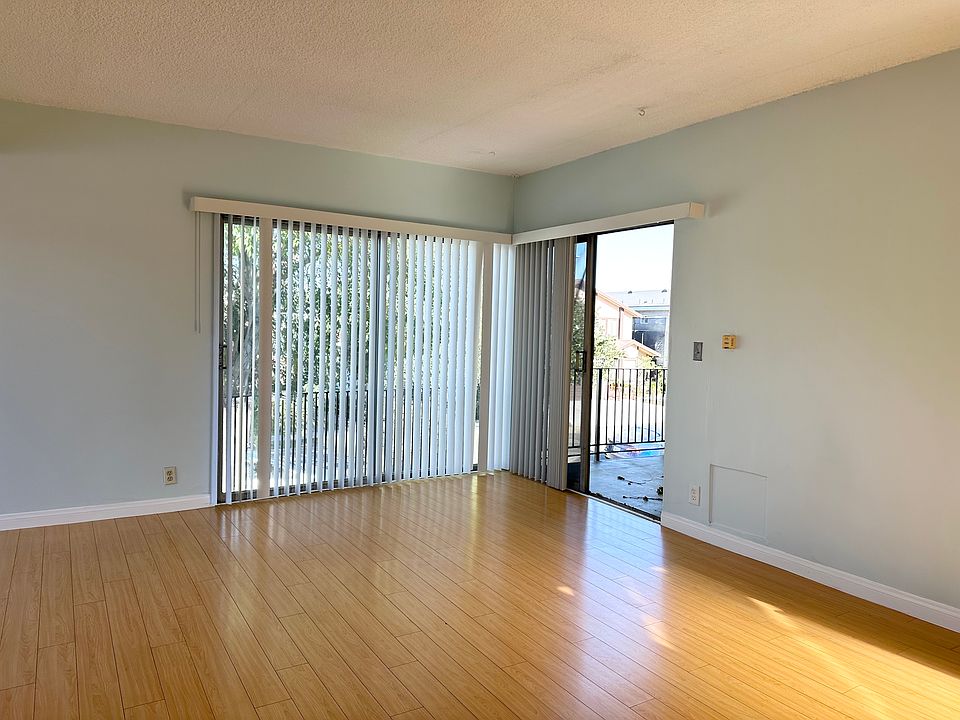 Living room with large windows and slider to private balcony