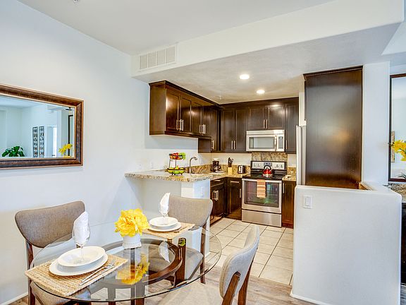 Kitchen and dining area at L'Estancia Apartment Homes