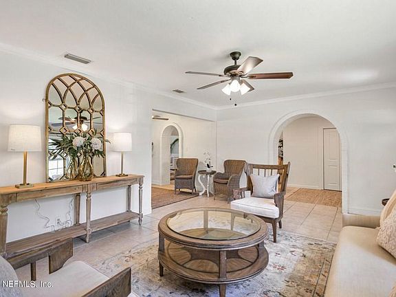 Living room (front of the house). Connects to kitchen, dining,, sitting area with fireplace, and guest bedrooms and bath.