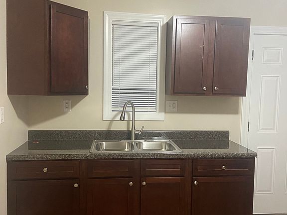 Newly updated kitchen featuring elegant granite countertops, abundant cabinet space for all your storage needs, washer/dryer hookups, and a gas stove hookup, perfect for home chefs.
