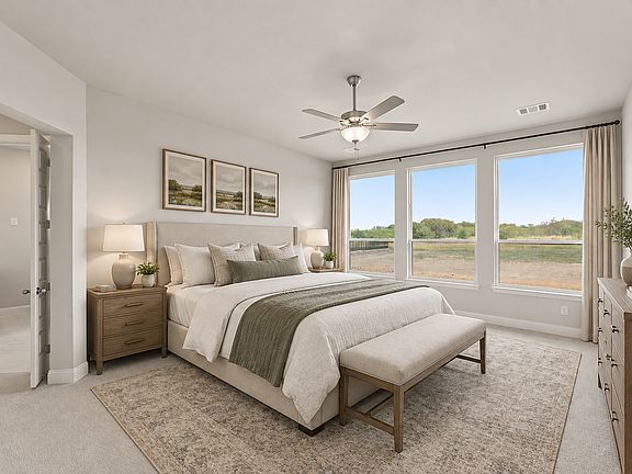 Virtually staged primary bedroom in a transitional ranch style home by Kindred Homes