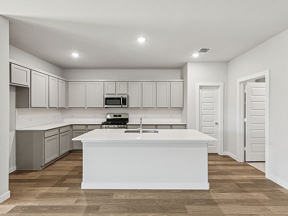 Kitchen in the Oscar home plan by Trophy Signature Homes - REPRESENTATIVE PHOTO