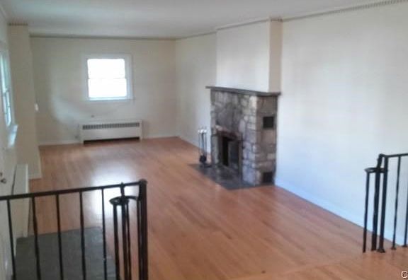 Sunken Living Room with the first of two stone fireplaces.