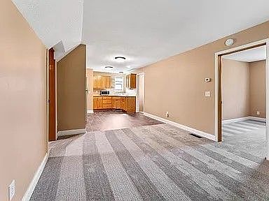 Photo of living room looking into the kitchen