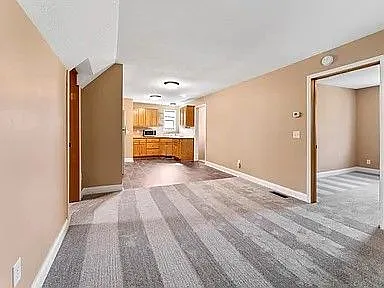 Photo of living room looking into the kitchen