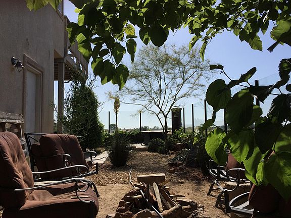 Backyard campfire pit with glass view wall.