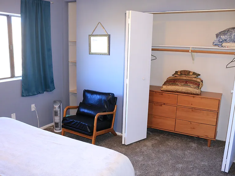 main bedroom, showing closet area and leather chair