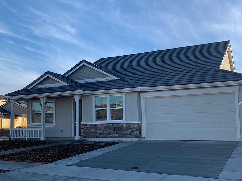 Elevation with two car garage, three car drive way and roadside parking
