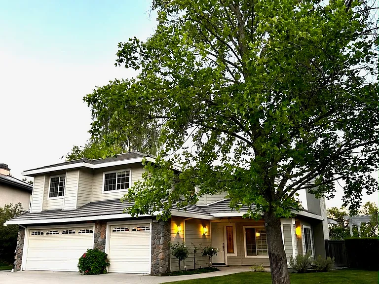 Beautiful home featuring a landscaped front lawn and attached 3-car garage