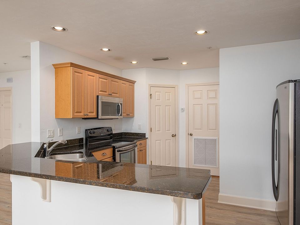 Large kitchen with granite countertops, large pantry, stainless appliances.