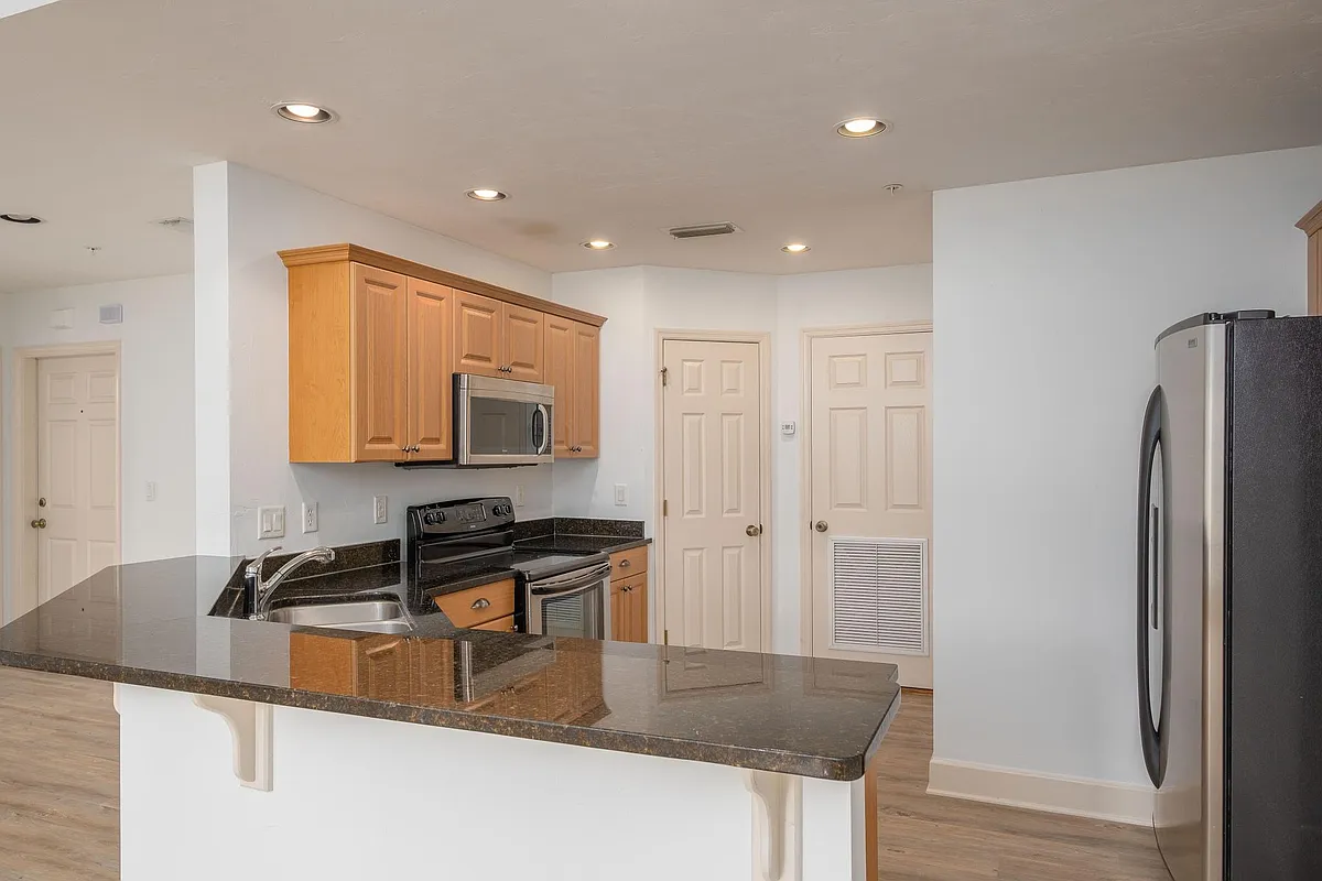 Large kitchen with granite countertops, large pantry, stainless appliances. - 5200 SW 91st Ter #202