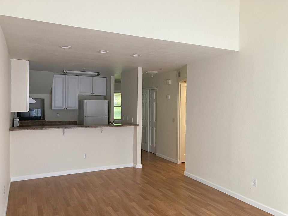 Living room facing kitchen with bar height counter for stools