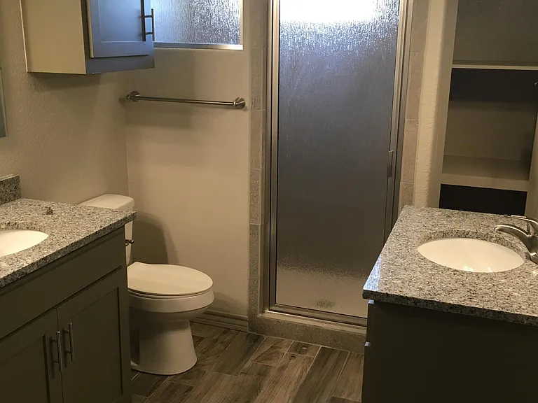 Dual vanities and walk-in shower with large walk-in closet