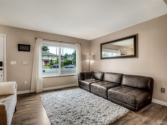 The living room is light and bright with large picture window and fresh paint.  Beautiful hardwood flooring is throughout the ma