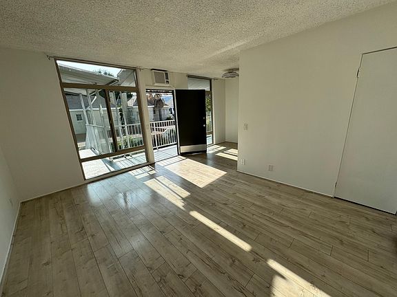 1st (top) floor apartment faces east-west. The living and dining room areas overlook the pool.