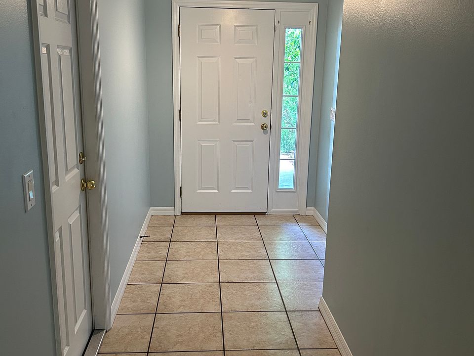 front door and hall, door on left to garage.