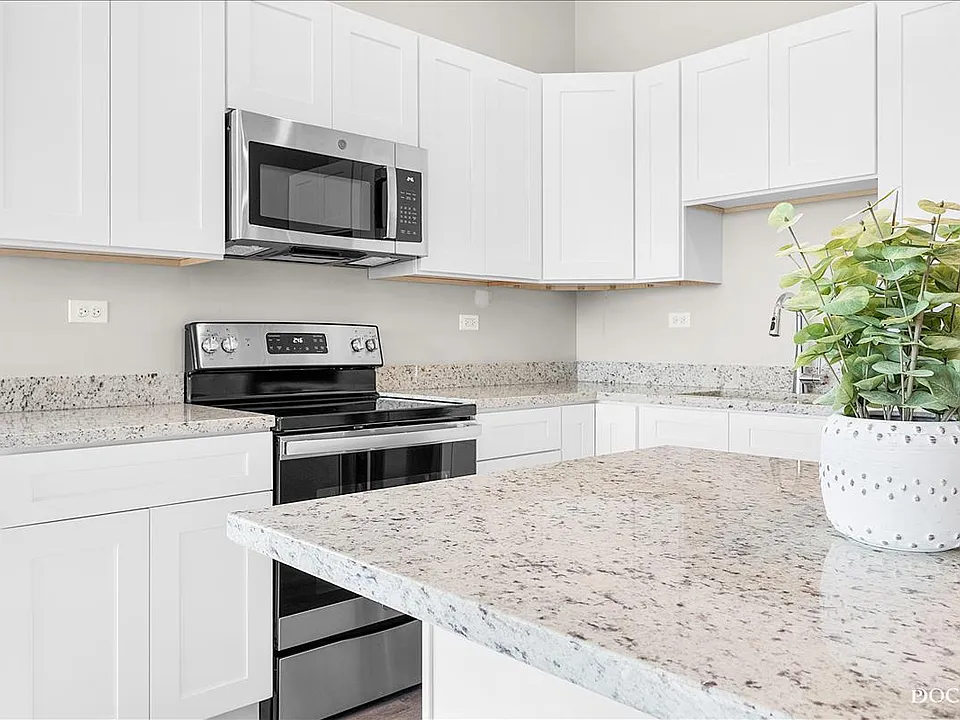 Kitchen with stainless steel appliances, soft close cabinets, and granite counters.