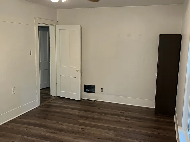 Second bedroom with high quality luxury vinyl and ceiling fan. Two large windows.