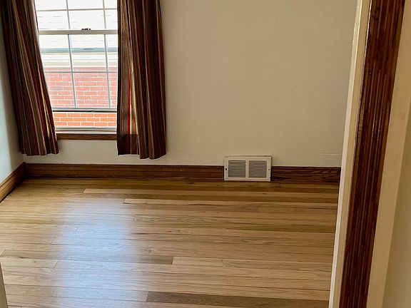 Small bedroom with freshly restored flooring