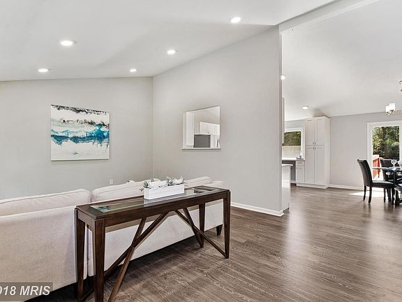 Living Room opens to Dining Room and Kitchen