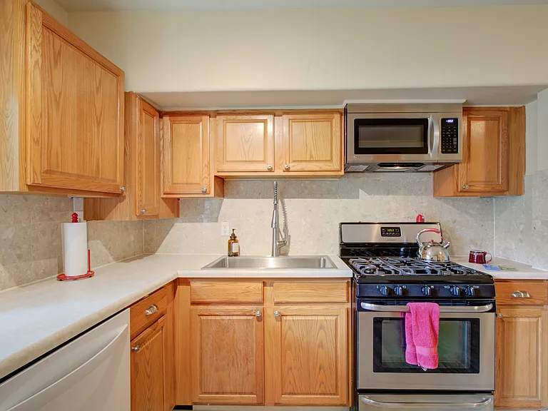 KITCHEN WITH NEW KOHLER STAINLESS SINGLE VESSEL SINK, GAS STOVE, OVER RANGE MICROWAVE