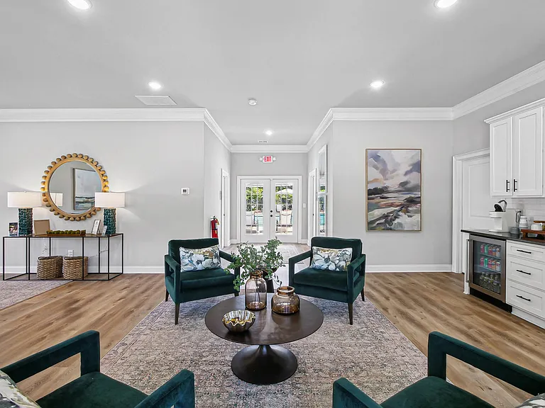 Spacious clubhouse lounge with ample seating and a convenient kitchenette.