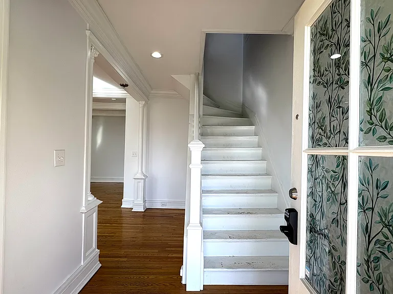 1st Fl - Front Entrance Foyer, Living Room (l), Stairs to 2nd Fl (c)