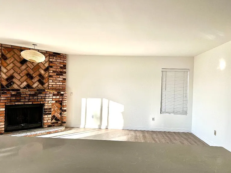Family room next to kitchen with fire place.