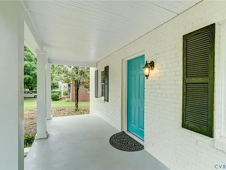 Full porch, recently painted! Imagine sipping coffee underneath the beautiful magnolia tree!