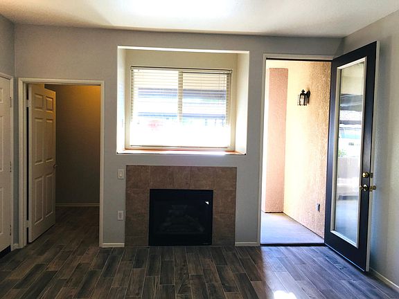 living room - storage next to entry door and to the right is exit onto private patio. Patio faces the parking lot and pool/fitness center