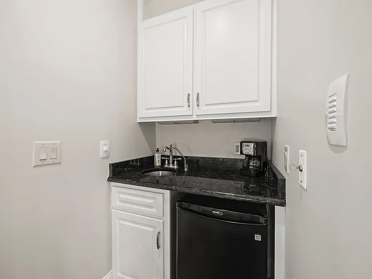Sink and Fridge Next to Upstairs Screened in Sunroom