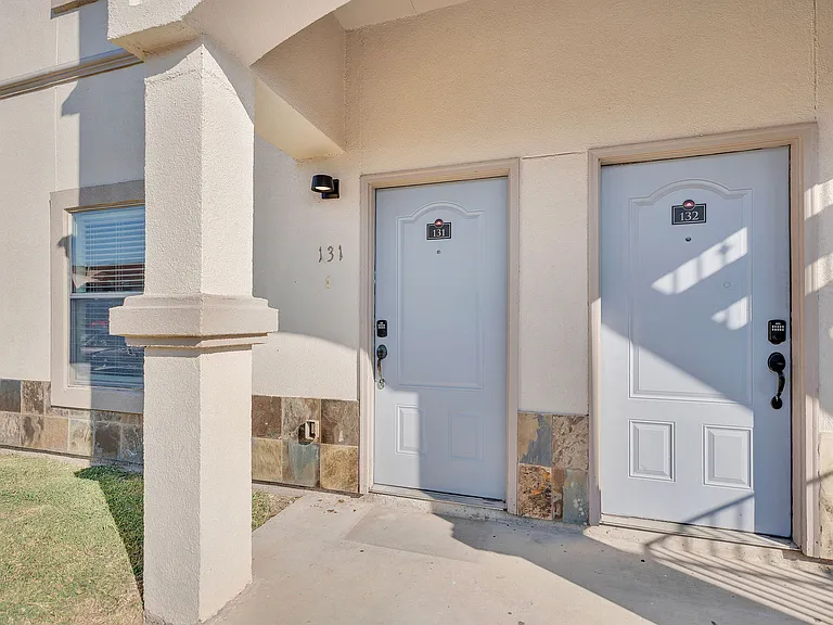 Chic front doors of Merida Vista Apartments in Laredo, Texas, inviting residents into a luxurious living space