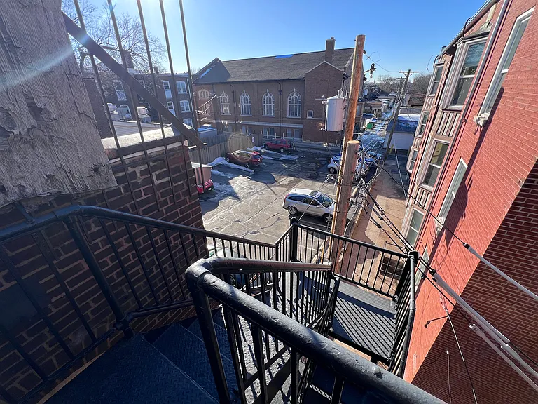 Rear fire escape. Overlooking our parking lot with reserved spaces. Please inquire about availability.