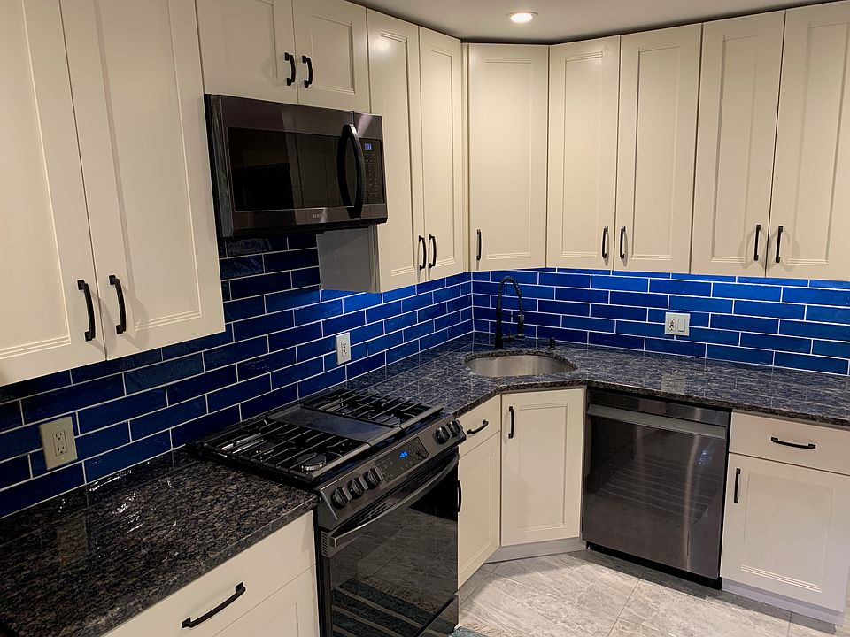 Updated kitchen with all black stainless steel Samsung appliances and granite countertoups.