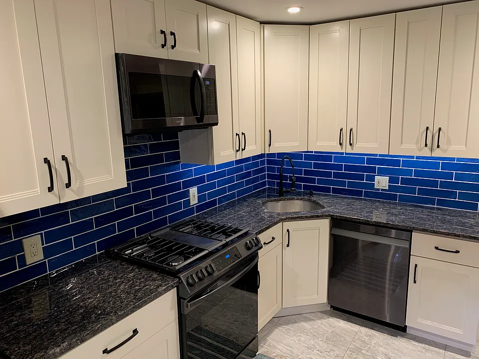 Updated kitchen with all black stainless steel Samsung appliances and granite countertoups.