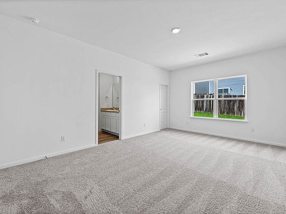 The master retreat includes its own walk-in closet and bathroom.