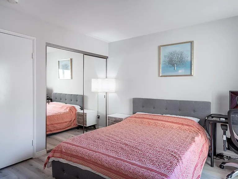 Downstairs bedroom with large closet, access to full bathroom and front patio