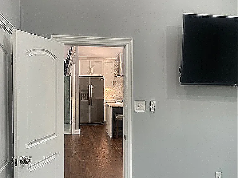 Large screen tv in bedroom.