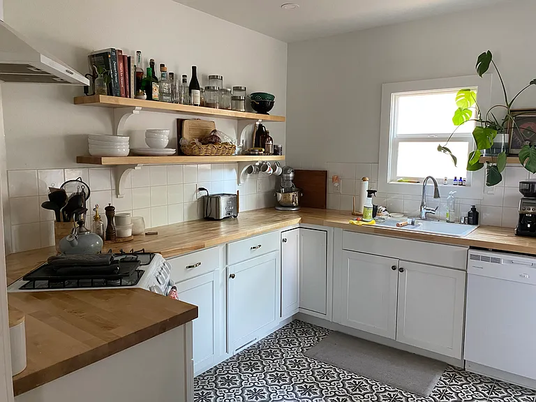 Kitchen features butcher block countertops, dishwasher, garbage disposal, microwave, and refrigerator.
