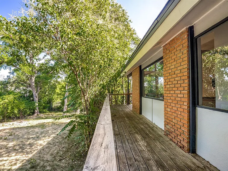 Expansive outdoor deck featuring wood flooring and a wood railing