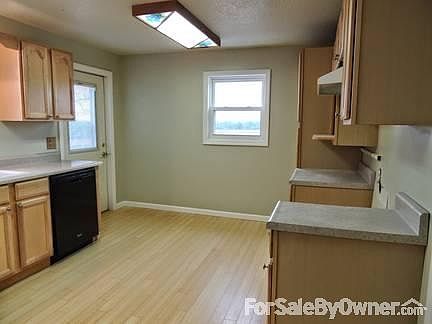 Kitchen was totally remodeled. Newer cabinets, flooring and windows.